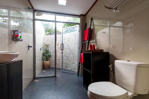 a bathroom with a toilet and a sink and a shower at Little Coco Gili Trawangan Villas in Gili Trawangan