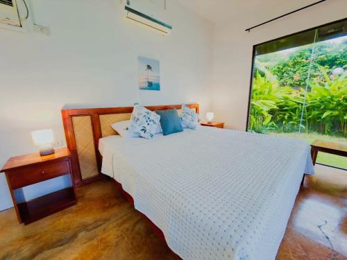 En eller flere senge i et værelse på Villas Flora Bella