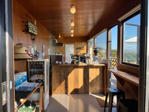 a kitchen with a counter and some windows at OceansideRanch Miyazaki in Miyazaki