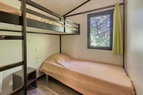 En eller flere senge i et værelse på Lou Pitchoun - Cottage pour 6