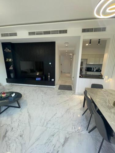 a large living room with a table and a kitchen at Dubai Hills Mahek Holiday Villa in Dubai