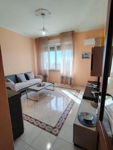 a living room with a couch and a table at La Playa di Ponente in Cagliari