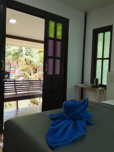 a blue towel sitting on top of a bed at DD Beach Houses in Phra Ae beach