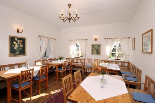 a dining room with tables and chairs and a chandelier at Stoffbauer GmbH in Graz