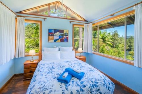 En eller flere senge i et værelse på Bellingen Riverside Cottages