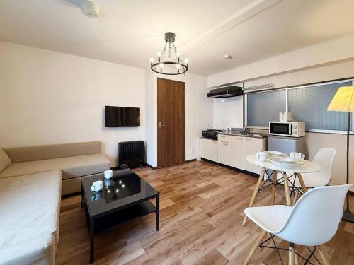 a living room with a couch and a table at Hottie - 1 Bedrm Apt 5mins from Hiroshima Sta 5ppl 302 in Hiroshima