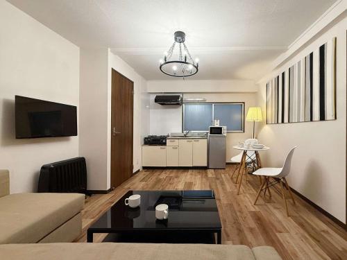 a living room with a couch and a table at Hottie - 1 Bedrm Apt 5mins from Hiroshima Sta 5ppl 302 in Hiroshima