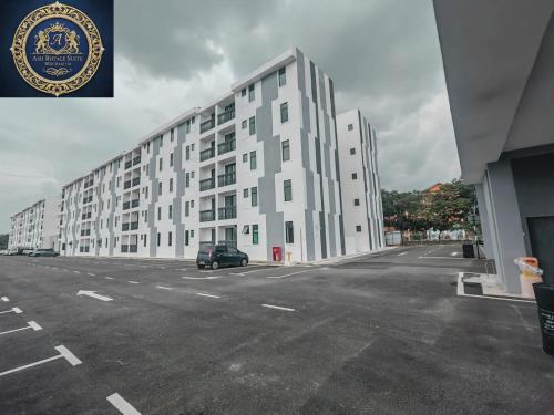 a large white building with a car parked in a parking lot at Ash Royale Suite - Bercham 138, Bandar Baru Putra, Ipoh, Perak in Kampong Batu Lapan
