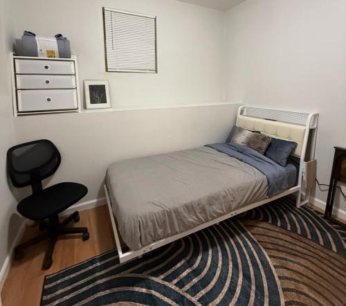 a bedroom with a bed and a chair and a desk at Comfy apt with skyline front view Mins away from NYC in Jersey City