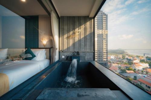 a hotel room with a bathtub with a waterfall at Lynntimes Thanh Thủy Wellness Hotel & Resort in La Phu