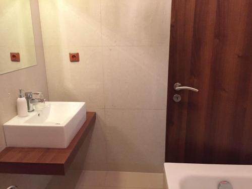 a bathroom with a white sink and a shower at Apartmán Fiona in Veľká Lomnica