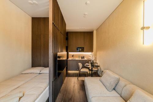 a small room with two beds and a table at Central Park Apartments - The Luxury Collection in Kaunas