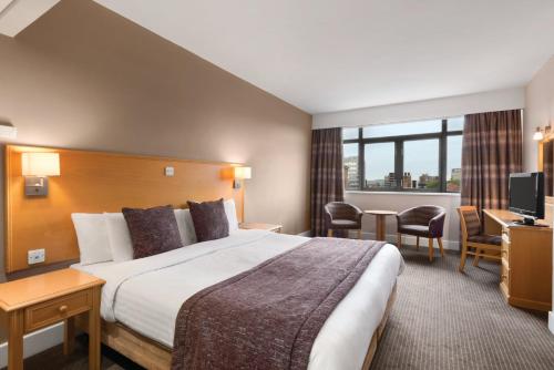 a hotel room with a bed and a television at Garner Hotel Nottingham City Centre by IHG in Nottingham