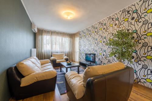 a living room filled with furniture and a window at Sofia Central Hotel Apartments in Sofia