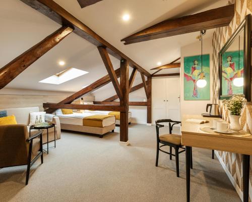 a bedroom with a bed and a desk in a room at Pałac w Małkowie in Warta