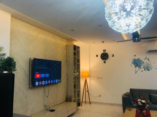 een woonkamer met een flatscreen-tv aan de muur bij Luxury Manzil in Lahore