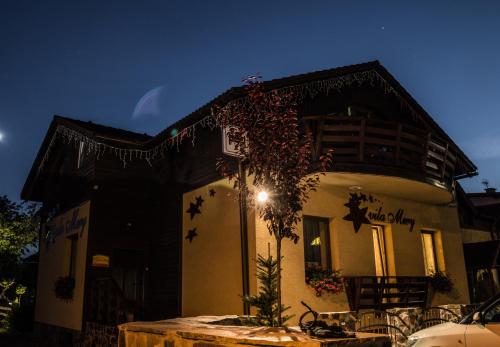 a house with a tree in front of it at Wellness Penzión Vila Mery in Poprad