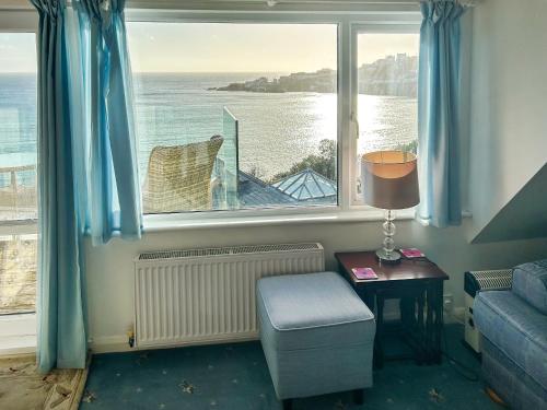 a room with a window with a view of the water at The Anchorage in Coverack