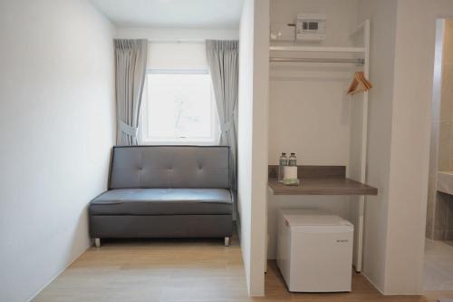 a small room with a bench and a window at Matini Hotel BU 
