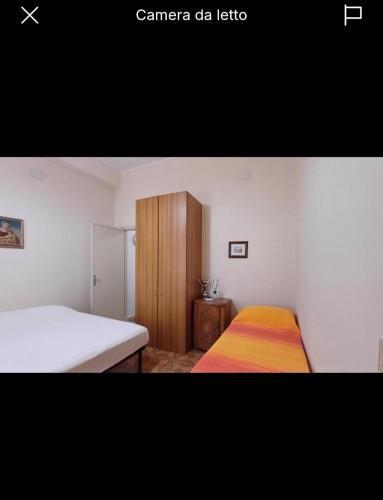 a bedroom with a bed and a wooden cabinet at Florina Appartment in Capo dʼOrlando