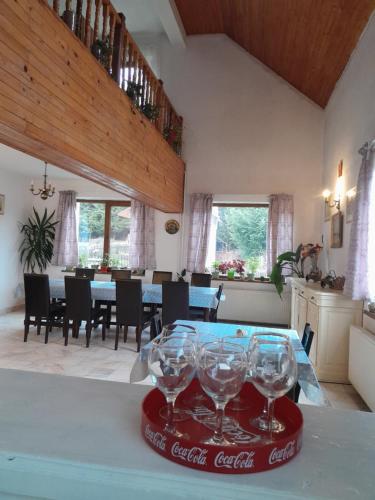 a dining room with a table with wine glasses on the table at Vila Kira Buşteni in Buşteni