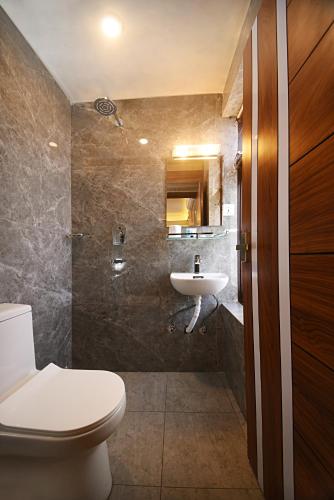 a bathroom with a toilet and a sink at Tibet Boutique Hotel Annex in Kathmandu
