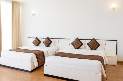 Ένα ή περισσότερα κρεβάτια σε δωμάτιο στο K-BOSS Hotel