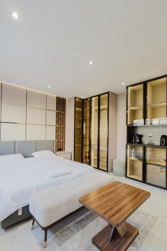 a bedroom with a large bed and a wooden table at Studio sky lux 94 in Tangier