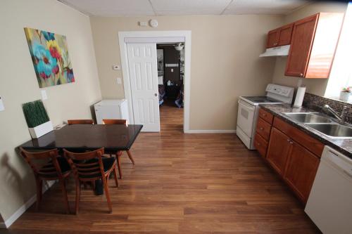 a kitchen with a table and chairs and a sink at Koreana in Decorah in Decorah