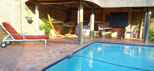 a house with a swimming pool and a patio at Kairos Home Guesthouse in Middelburg