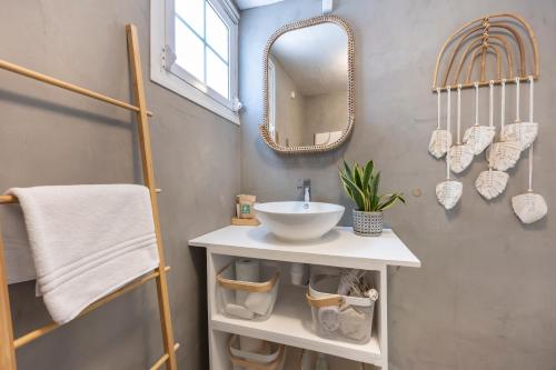 a bathroom with a sink and a mirror at Casa Ladeira in Loulé