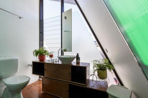 a bathroom with a sink and a toilet and a mirror at Melbourne suites - Zen Oasis or skyline views in Melbourne