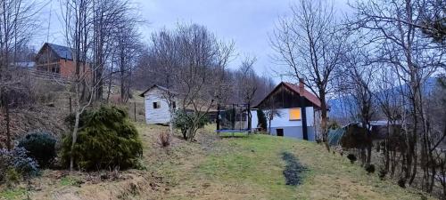 a house on the side of a hill with trees at Dom w górach Zacisze lasu in Sucha Beskidzka