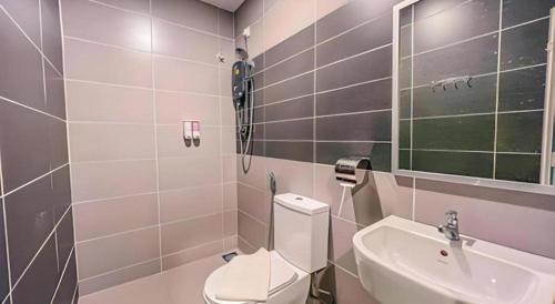 a bathroom with a toilet and a sink at TT Dorf Hotel (Taiping) in Taiping