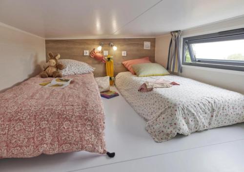 a bedroom with two beds and a teddy bear at Weekend Glamping Resort in San Felice del Benaco