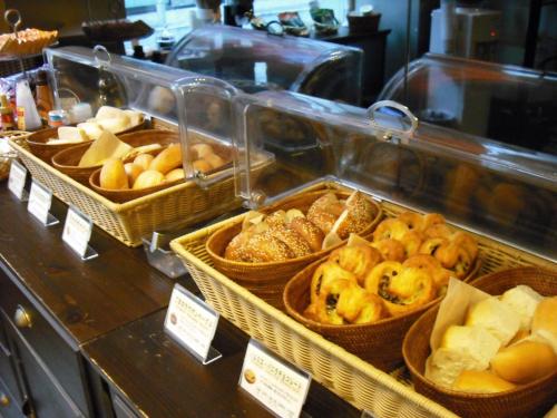 a display case with baskets of bread and pastries at Akasaka Granbell Hotel in Tokyo