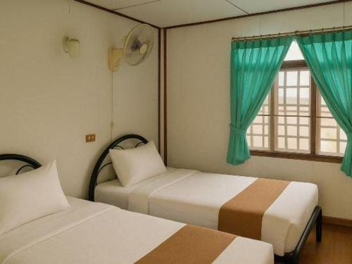 Postel nebo postele na pokoji v ubytování Palm Point Village