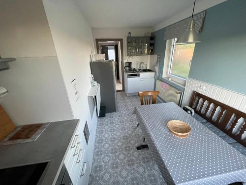 Funnenser Deichhaus في انجرلاند: مطبخ صغير مع طاولة وثلاجة