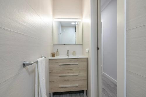 un baño con lavabo y espejo en Grey House, en Huelva