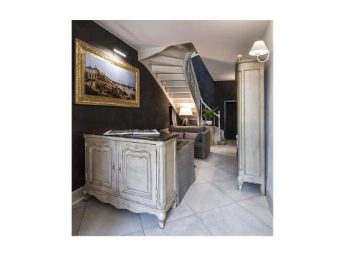 a hallway with a staircase and a living room at La Sauternaise, luxury Boutique B&B in Sauternes