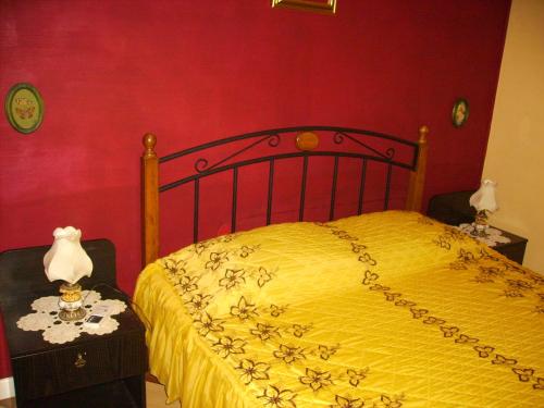 a bedroom with a bed with a yellow blanket at Villa Marija in Punat