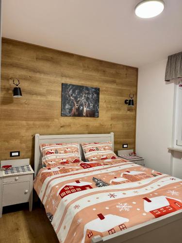 a bedroom with a large bed with a wooden headboard at Bardo Chalet in Bardonecchia