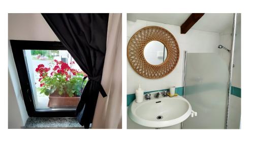 a bathroom with a sink and a mirror and a window at La Colombara in Ponte dellʼOlio