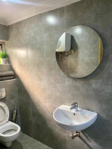 a bathroom with a sink and a mirror on the wall at Angel Hotels in Lagos