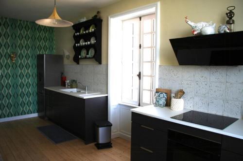 a kitchen with a sink and a window at Charming Gite In Mont Saint Vincent in Mont-Saint-Vincent