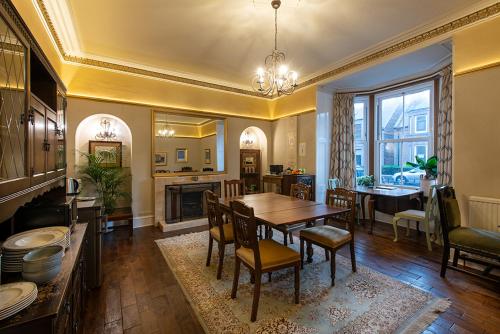 a kitchen and dining room with a table and chairs at Trinity Boutique B&B in Peterhead
