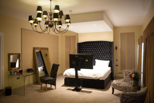 a bedroom with a bed and a chandelier at Hotel Forty One in Great Driffield