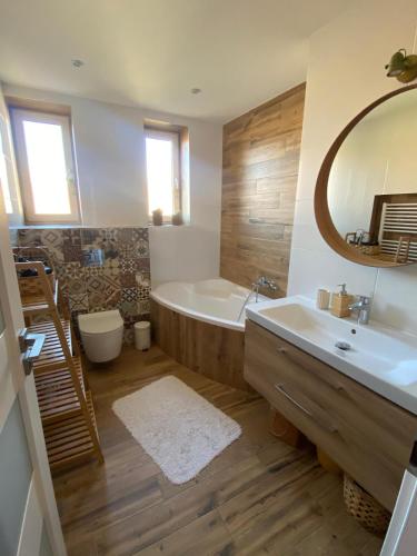 a bathroom with a tub and a toilet and a sink at Apartmán Jedľa pod Tatrami in Jezersko