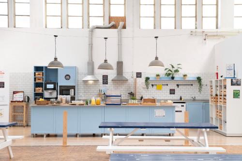 a kitchen with a blue counter in a room at WOT Peniche Social in Peniche