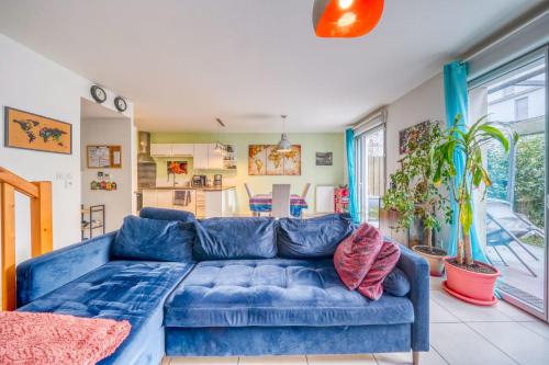 a blue couch in a living room with at Bright house ideal for exploring Bordeaux in Bordeaux